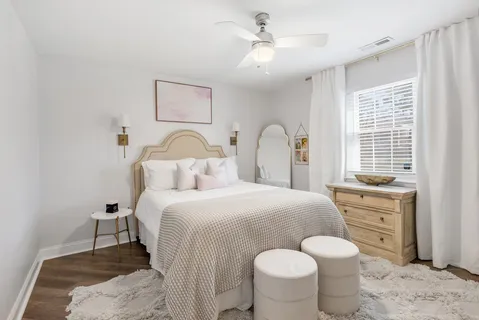 a bedroom with a bed and a chandelier