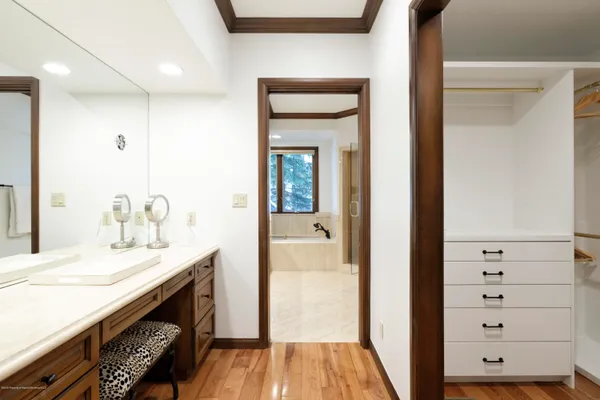 a bathroom with a sink a vanity and a mirror