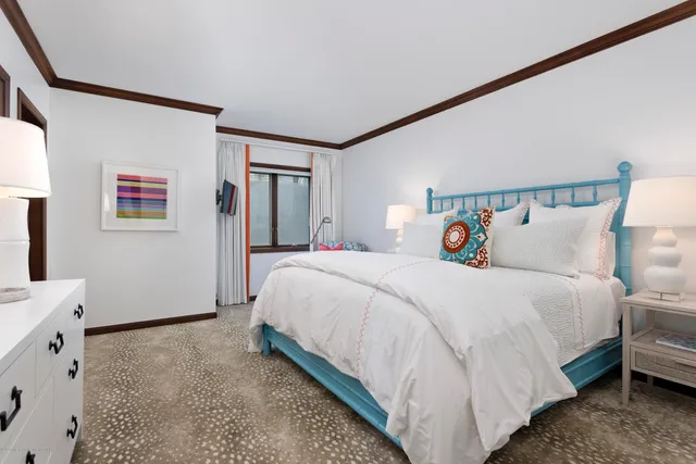 a bedroom with bed and a window