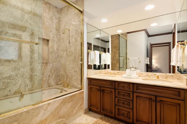 a bathroom with a granite countertop sink mirror and shower
