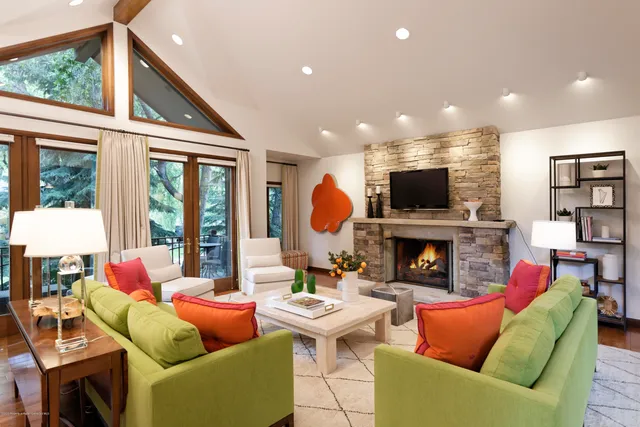a living room with fireplace furniture and a flat screen tv