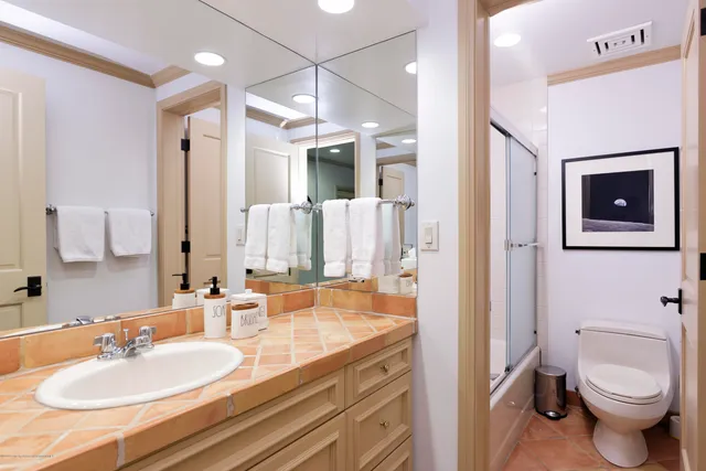 a bathroom with a sink toilet and shower