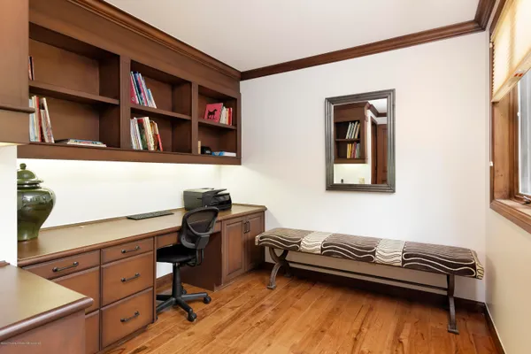 a bedroom with a bed and a bookshelf