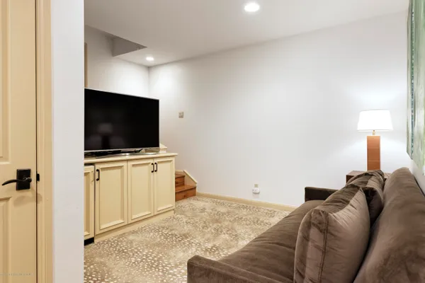 a living room with a flat screen tv and a fireplace