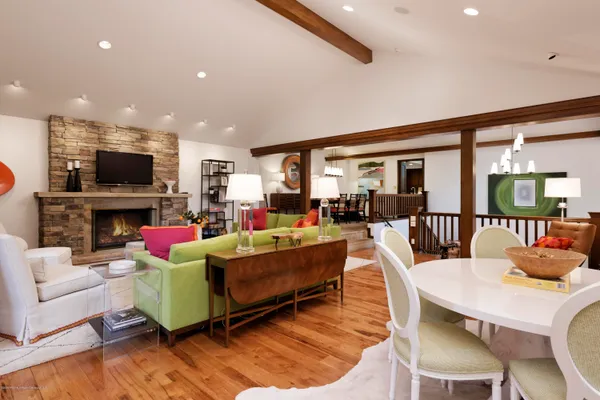 a living room with fireplace furniture and a flat screen tv