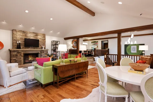 a living room with fireplace furniture and a flat screen tv