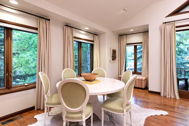 a view of a dining room with furniture window and wooden floor