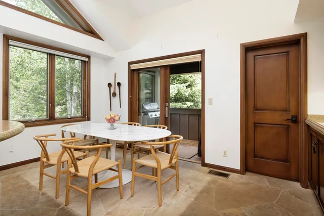 a view of a dining room with furniture window and outside view