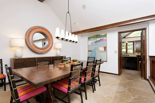 a view of a dining room with furniture and chandelier