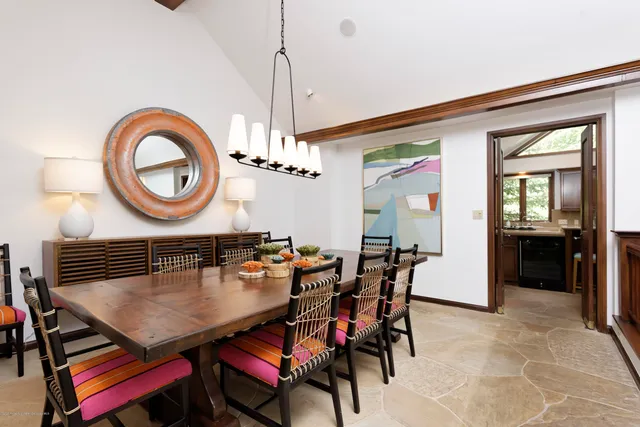a view of a dining room with furniture and chandelier