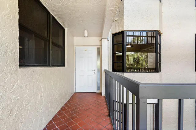 a view of a hallway with wooden floor and a window