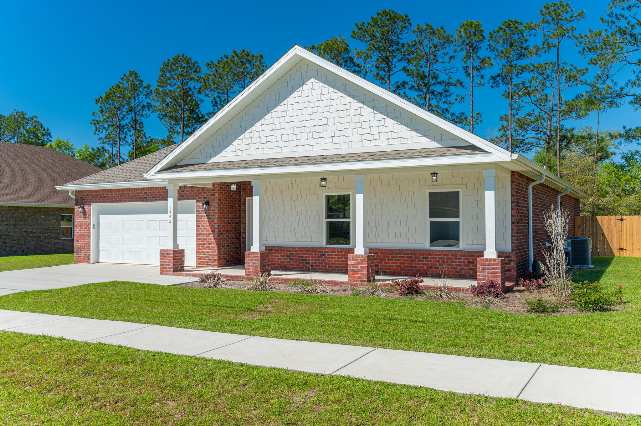 a front view of a house with a yard and porch