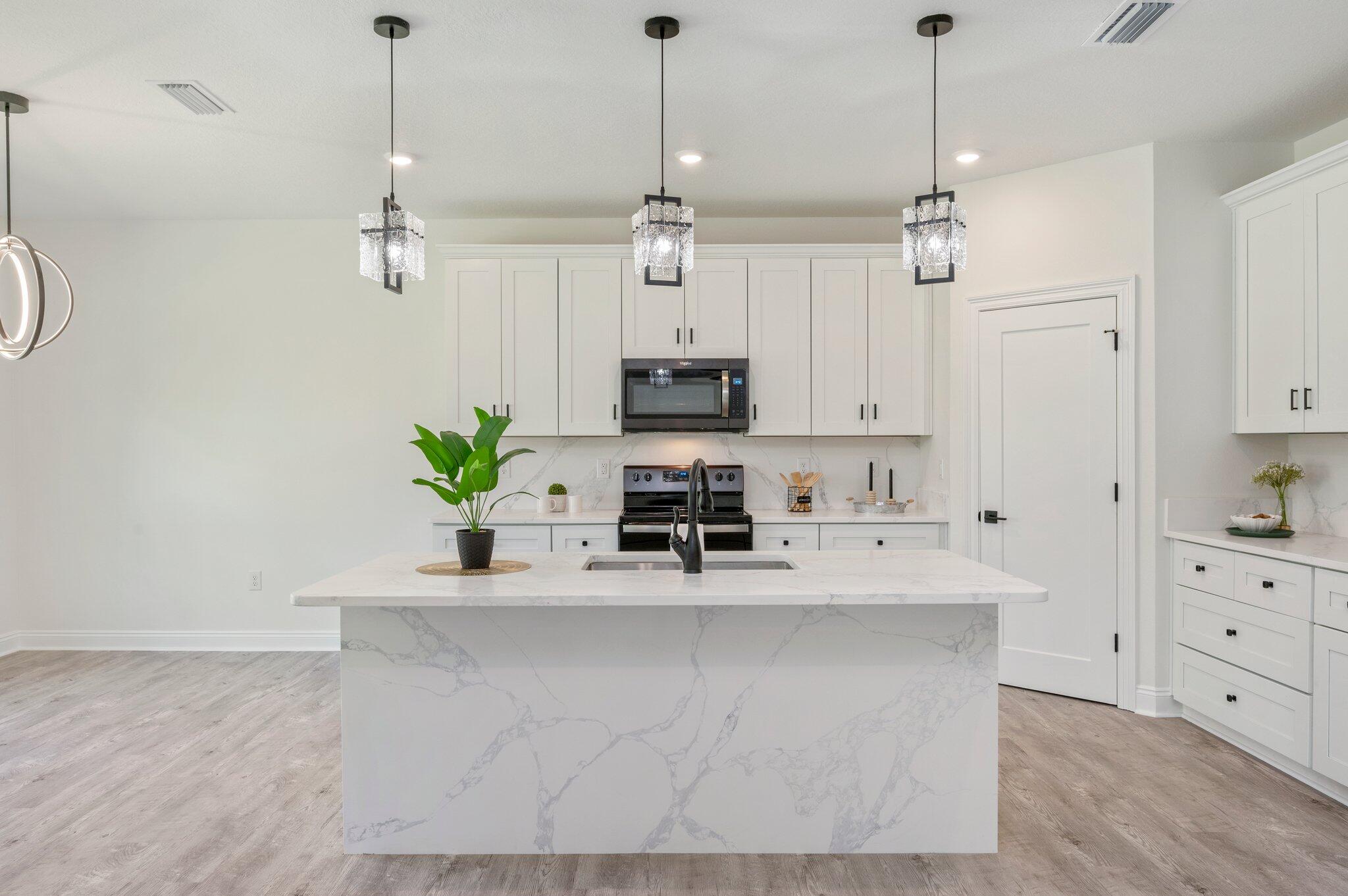 5448 Jenee Court Crestview, FL 32539 - Photo 11 of 42 a kitchen with refrigerator and white cabinets