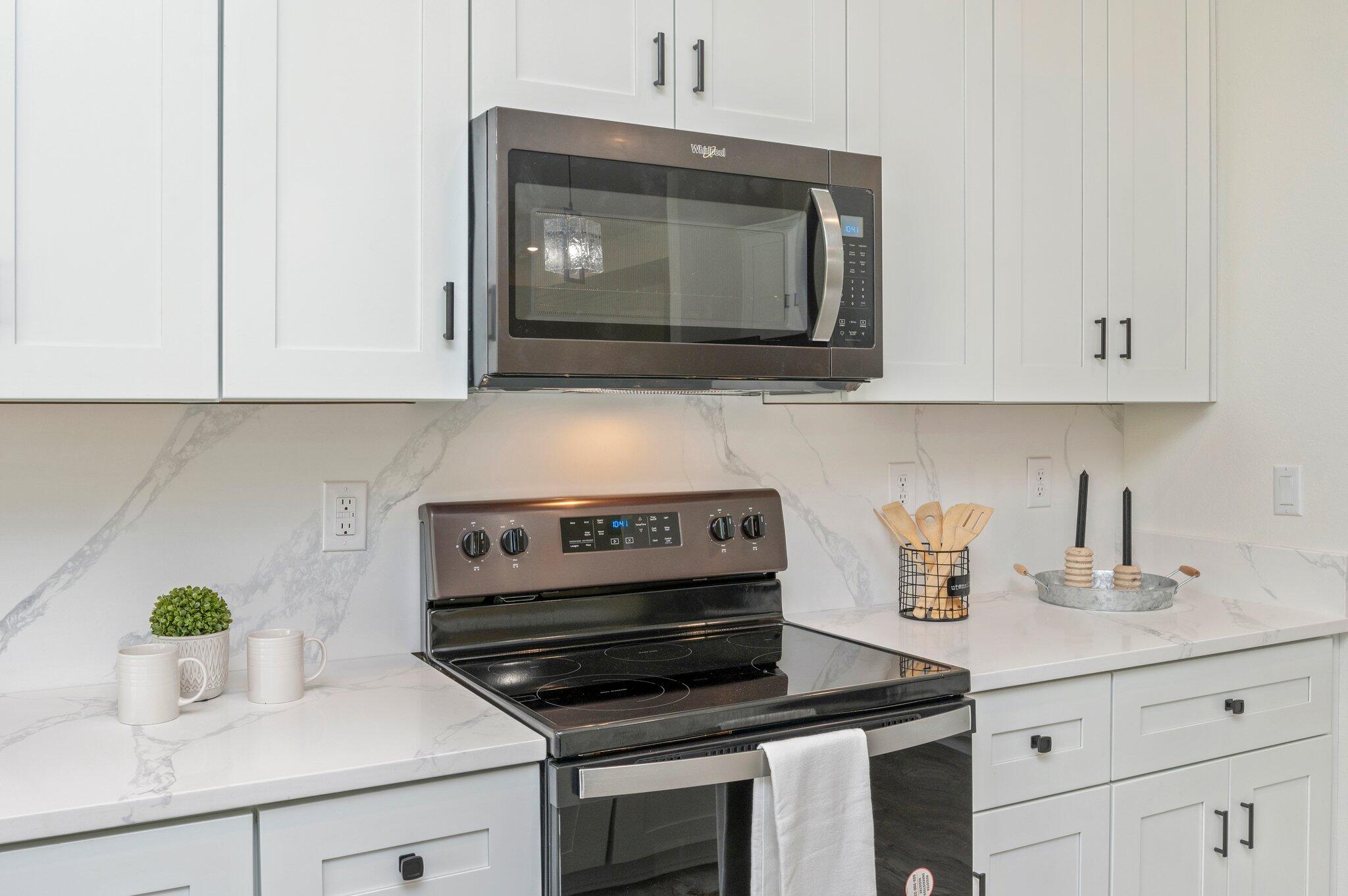 5448 Jenee Court Crestview, FL 32539 - Photo 15 of 42 a kitchen with a stove and a white cabinets