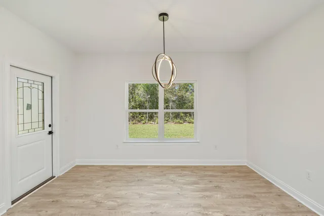 an empty room with windows and outdoor view