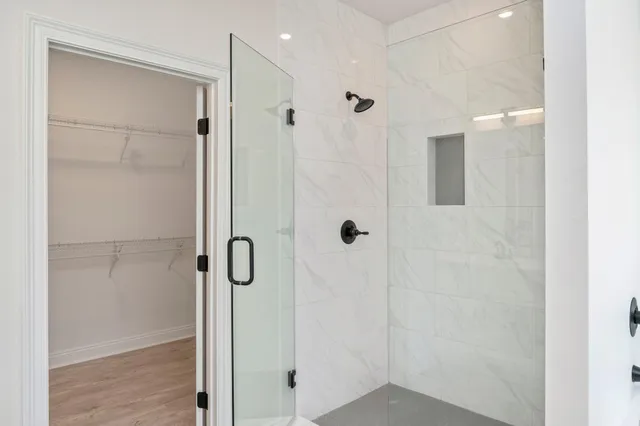 a bathroom with a shower and a glass door