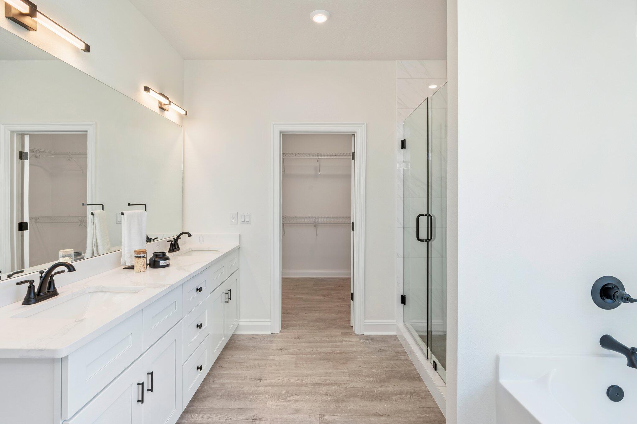 5448 Jenee Court Crestview, FL 32539 - Photo 24 of 42 a bathroom with a double vanity sink a mirror and a bathtub