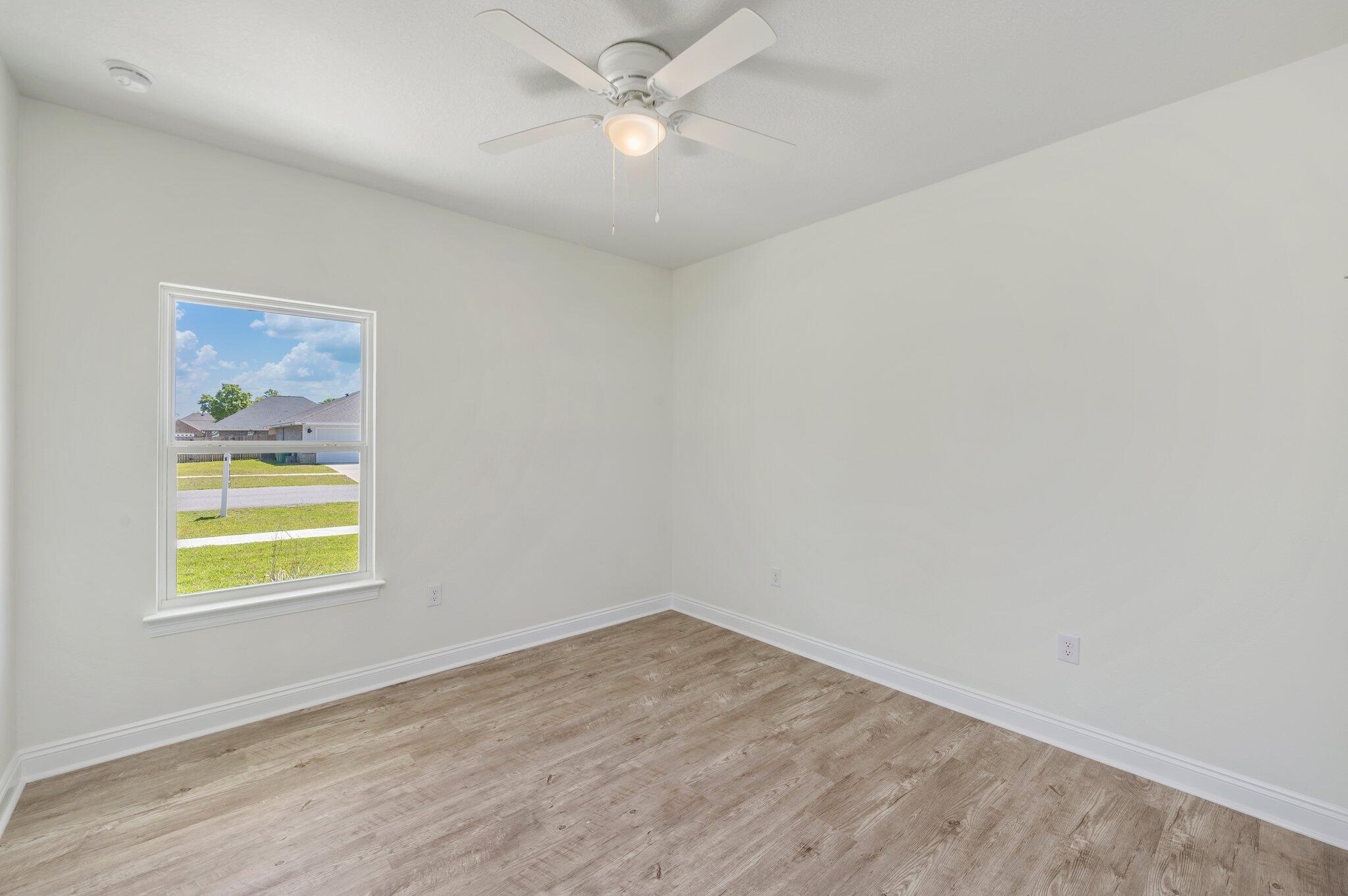 5448 Jenee Court Crestview, FL 32539 - Photo 27 of 42 an empty room with a window and ceiling fan