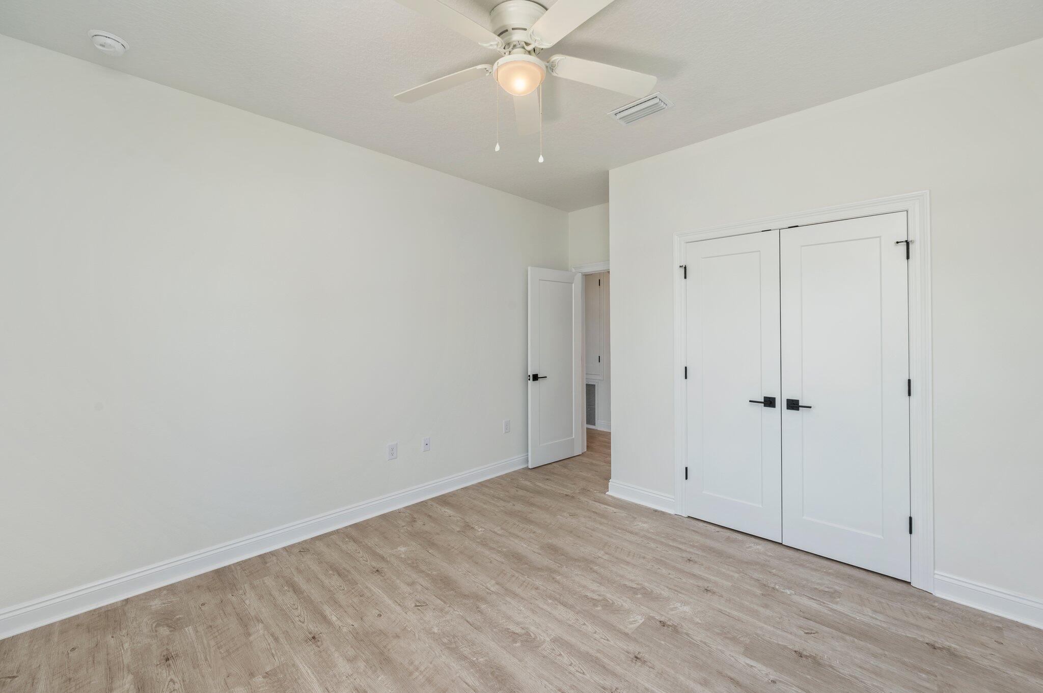 5448 Jenee Court Crestview, FL 32539 - Photo 30 of 42 a view of an empty room with wooden floor