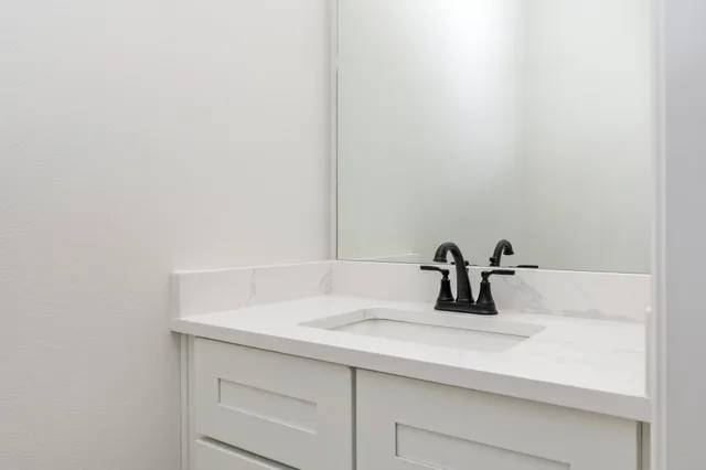a bathroom with a sink and vanity
