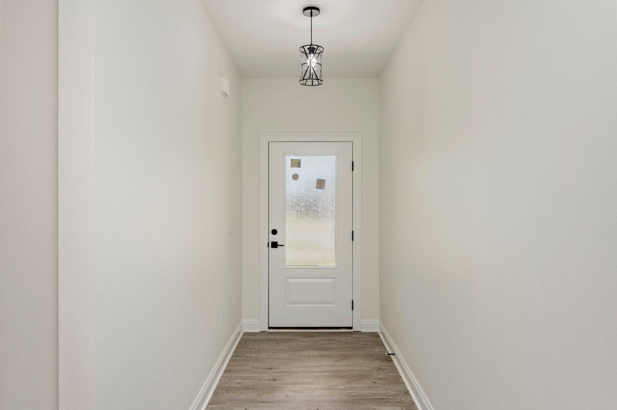 5448 Jenee Court Crestview, FL 32539 - Photo 5 of 42 a view of a hallway with a chandelier