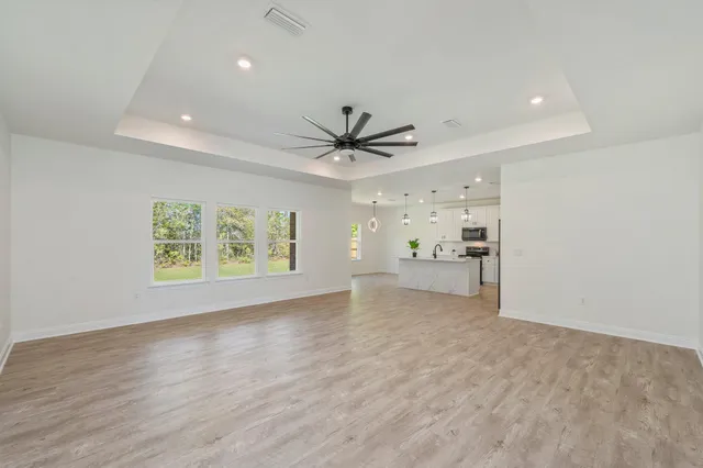 an empty room with closet and windows