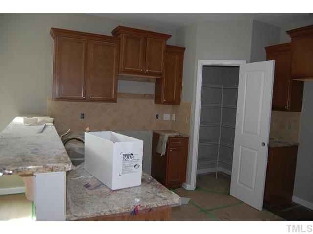 4506 Cardinal Grove Boulevard, Unit LT221 Raleigh, NC 27616 - Photo 3 of 23 a kitchen with stainless steel appliances granite countertop a refrigerator and a stove top oven