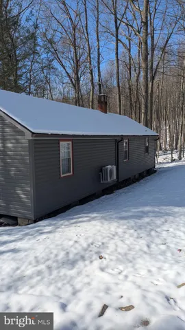 a view of a small house with a yard