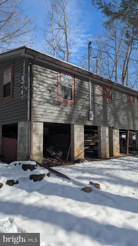 a view of a yard with snow on the road