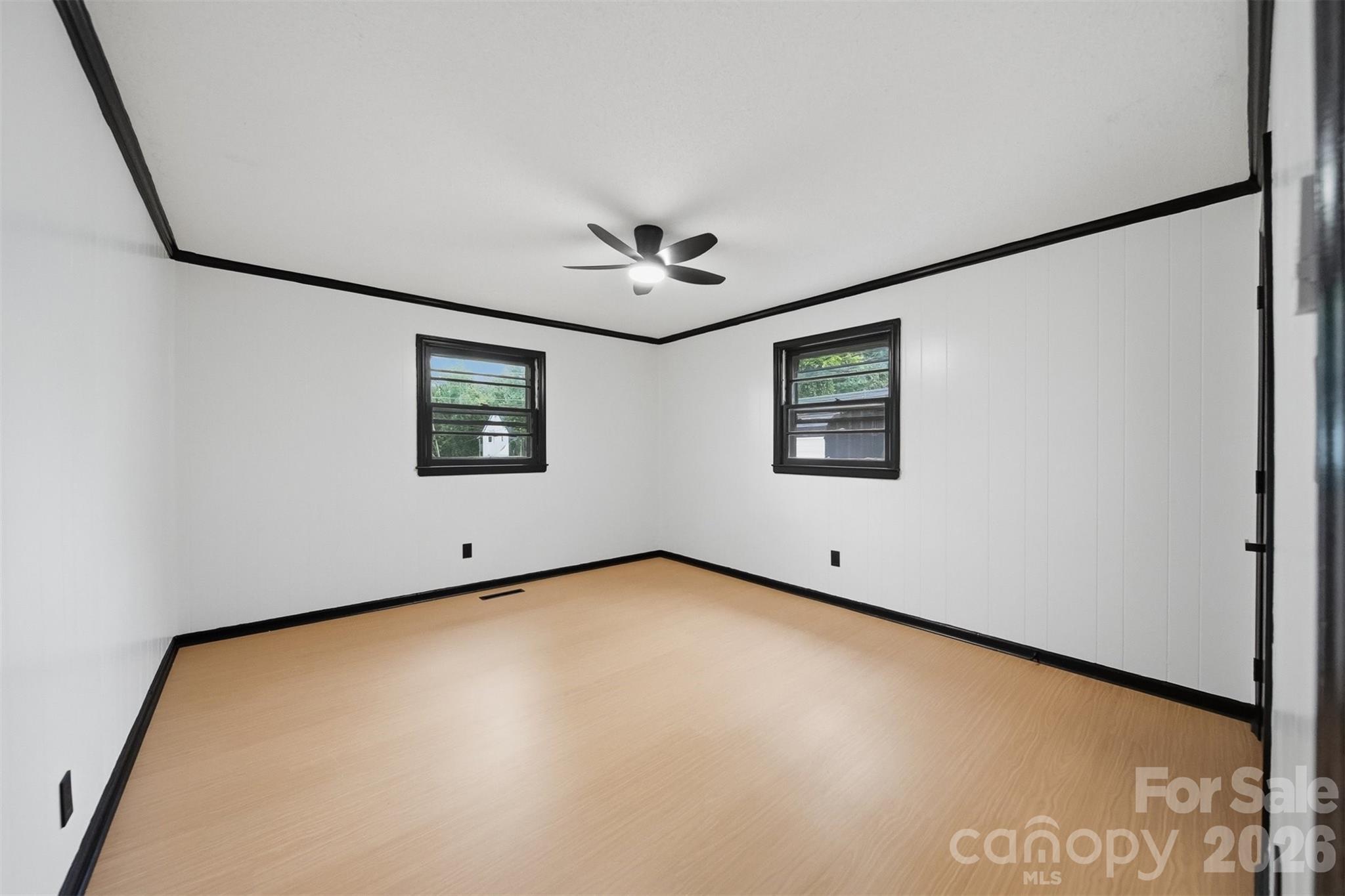 201 Cape Hickory Road Hickory, NC 28601 - Photo 8 of 16 a view of a big room with windows and a ceiling fan