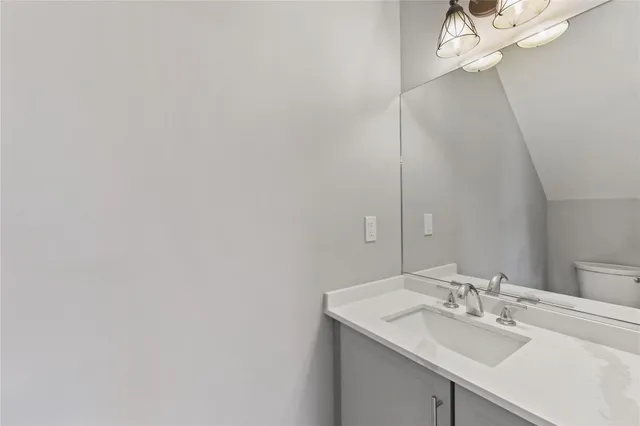 a bathroom with a sink vanity and a mirror