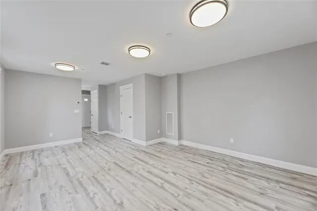 a view of room with wooden floor