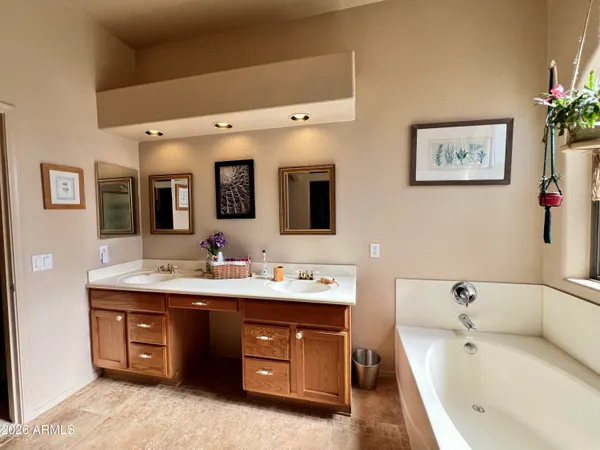 a spacious bathroom with a double vanity sink and a bathtub