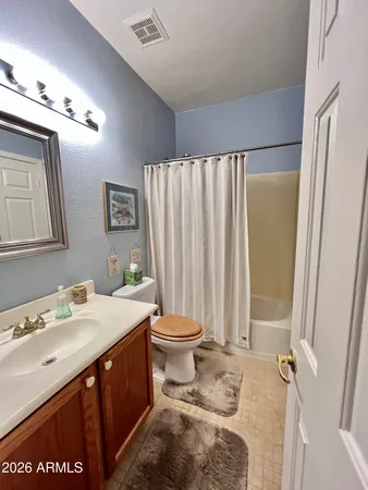 a bathroom with a double vanity sink toilet and a mirror