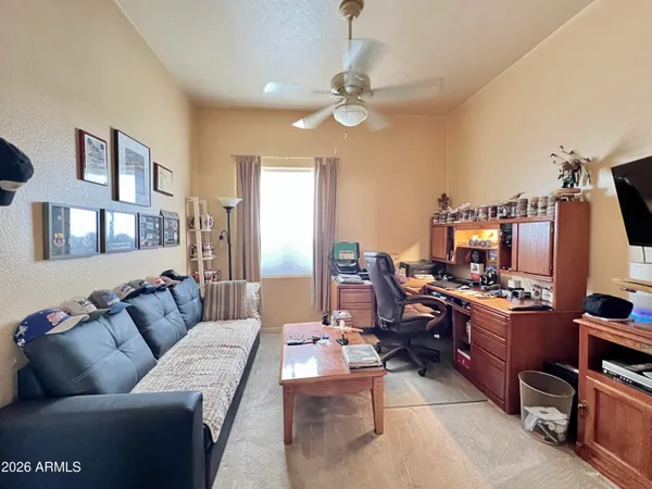 a living room with furniture kitchen view and a flat screen tv