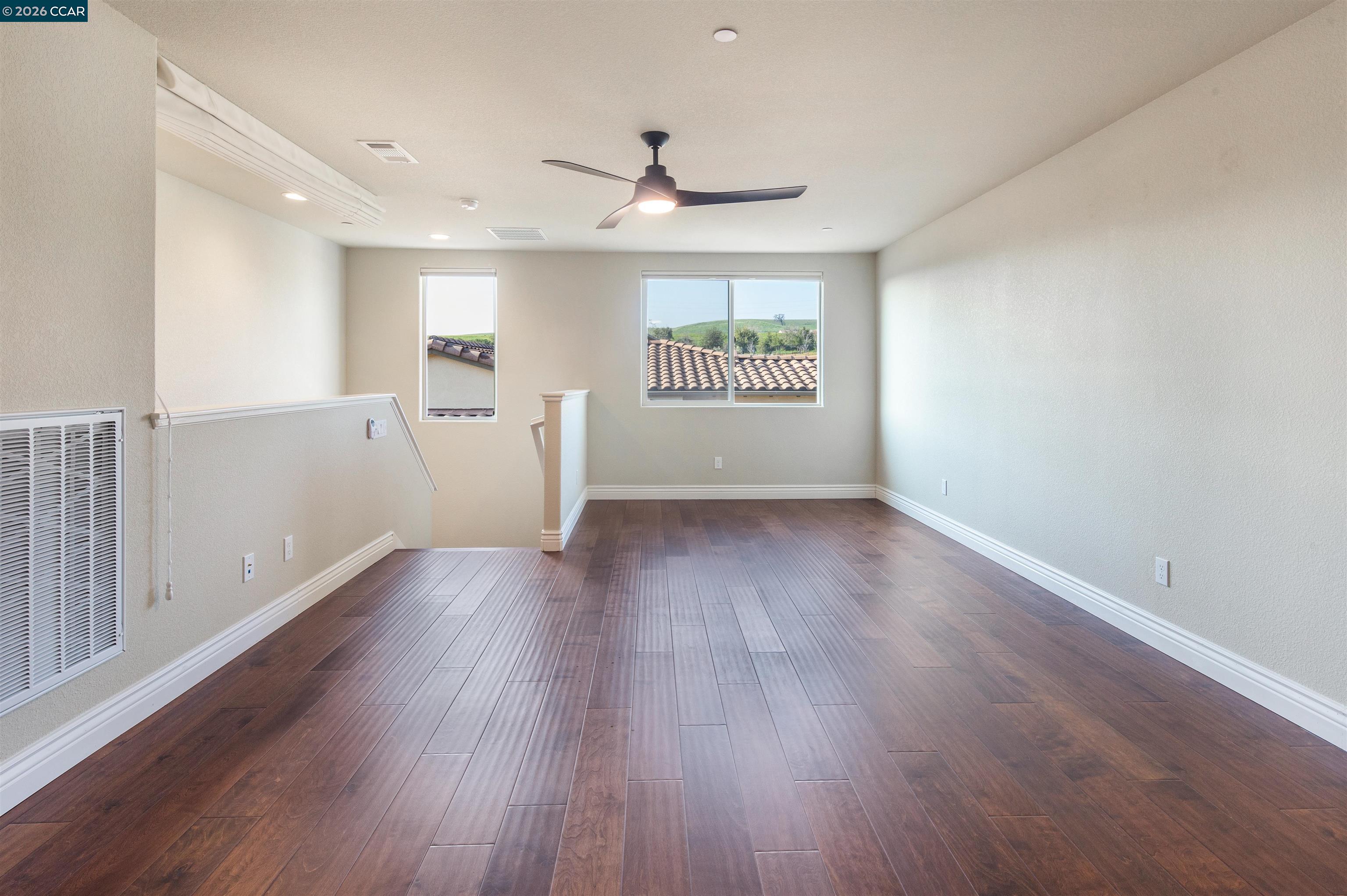2090 Rioja Way Brentwood, CA 94513 - Photo 9 of 48 a view of an empty room with wooden floor and a window
