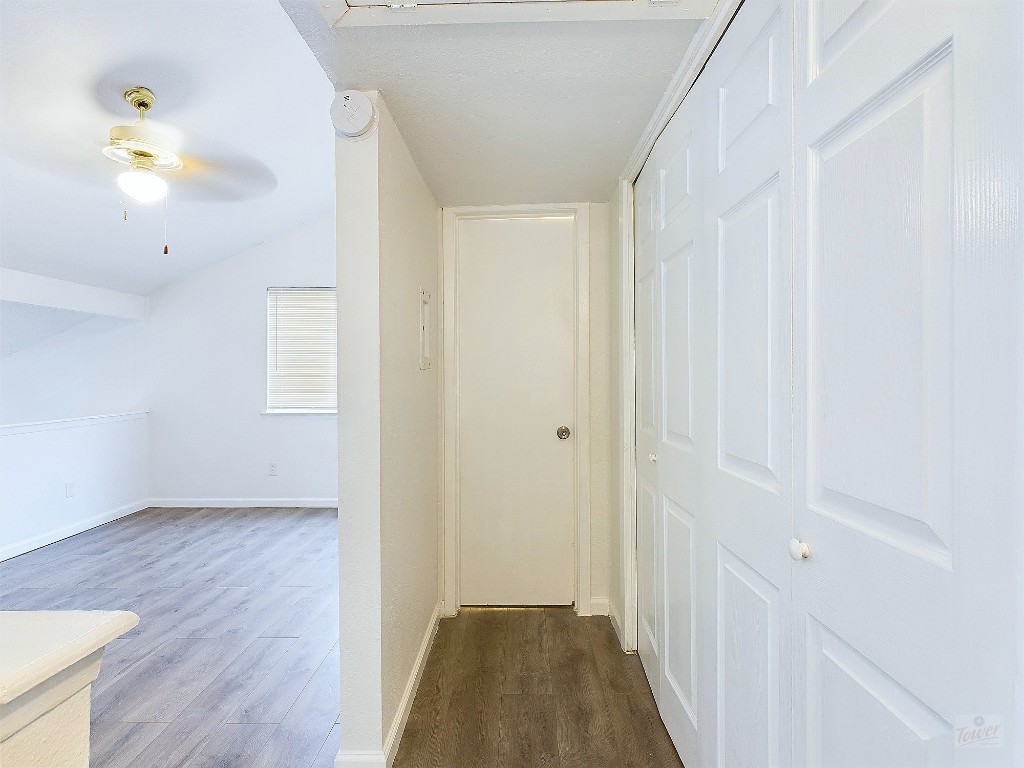 2124 Burton Drive, Unit 140 Austin, TX 78741 - Photo 13 of 22 a view of a hallway with wooden floor and a chandelier