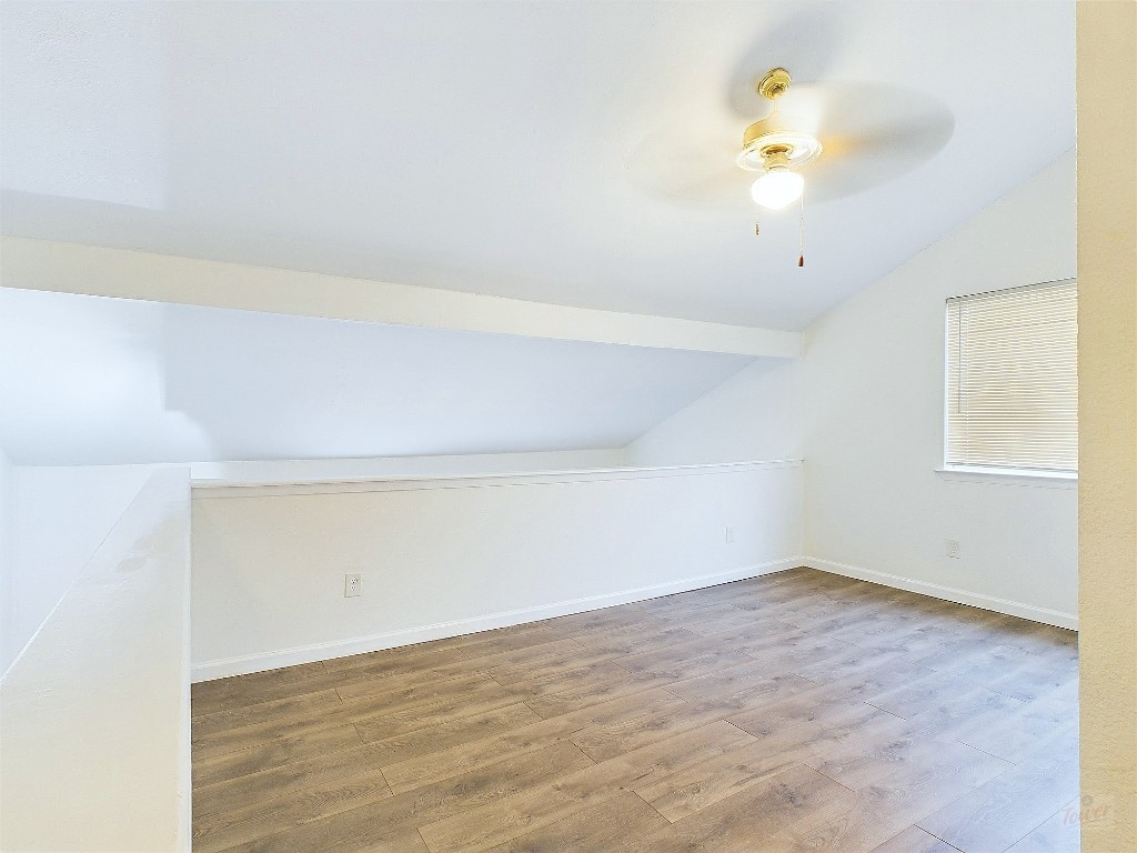 2124 Burton Drive, Unit 140 Austin, TX 78741 - Photo 14 of 22 a view of a room with wooden floor and ceiling fan