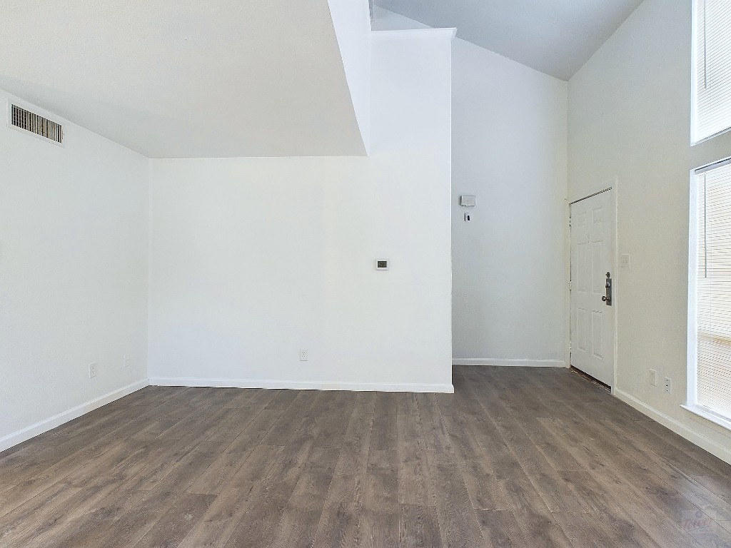 2124 Burton Drive, Unit 140 Austin, TX 78741 - Photo 4 of 22 an empty room with wooden floor