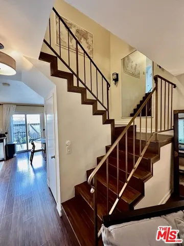 a view of entryway and hall with wooden floor