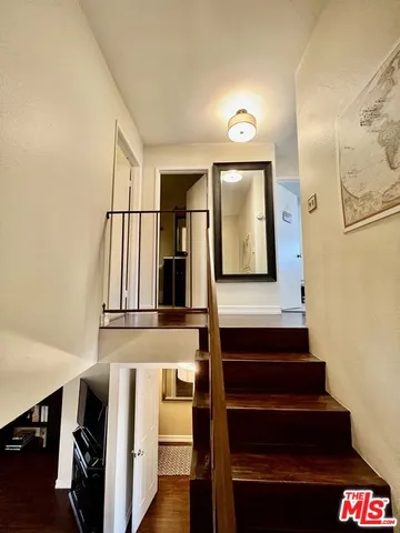a view of entryway and hall with wooden floor