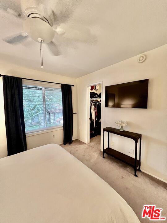 27574 Rondell Street Agoura Hills, CA 91301 - Photo 14 of 26 a bedroom with a bed and a flat screen tv