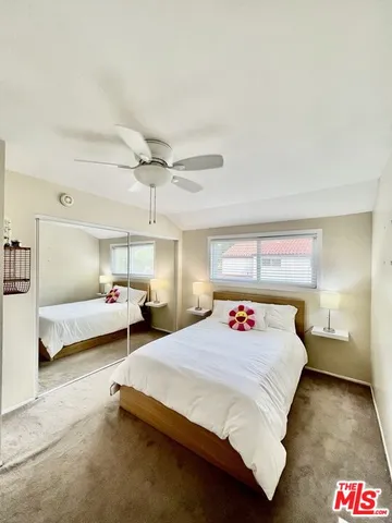 a bedroom with bed and window