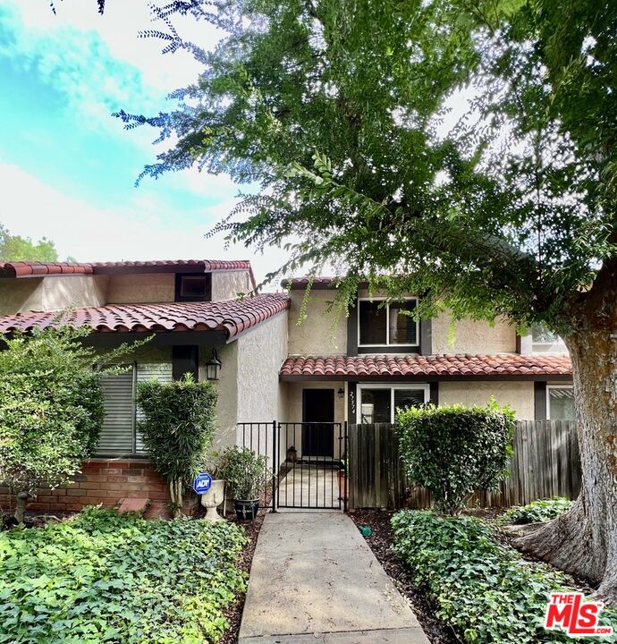 27574 Rondell Street Agoura Hills, CA 91301 - Photo 2 of 26 a front view of a house with a garden