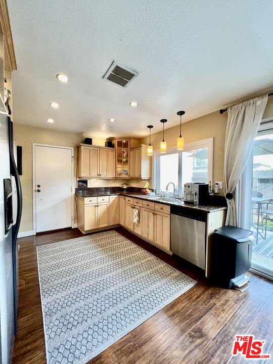 27574 Rondell Street Agoura Hills, CA 91301 - Photo 7 of 26 a kitchen with stainless steel appliances granite countertop a refrigerator a stove and a wooden floors