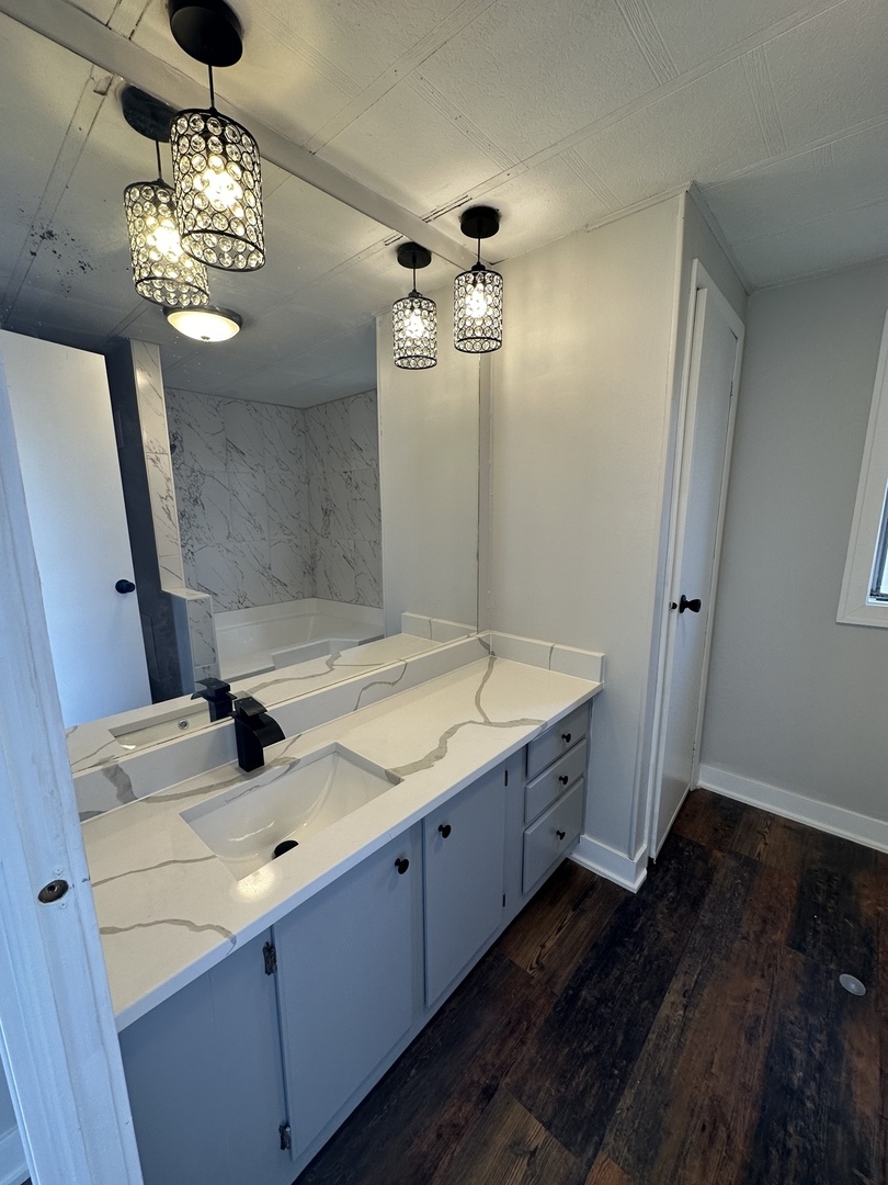 11 Hearthside Drive Matteson, IL 60443 - Photo 4 of 10 a bathroom with a granite countertop sink a large mirror and a shower