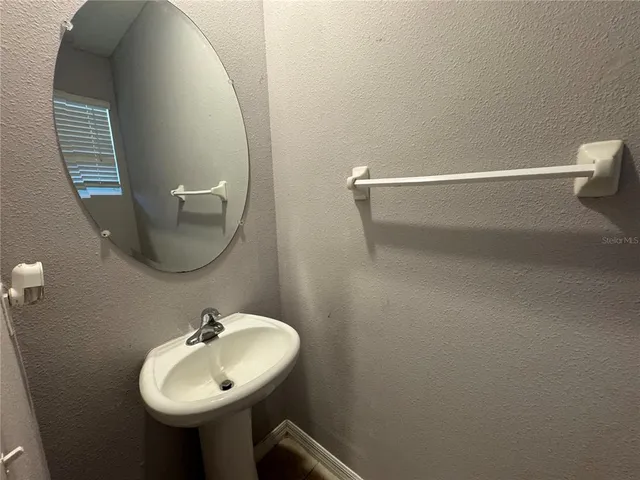 a bathroom with a sink and mirror