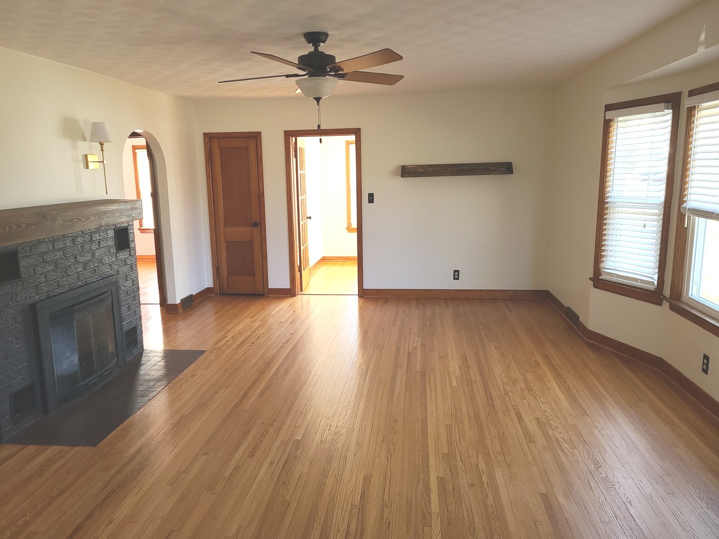 1045 North 9th Street Rochelle, IL 61068 - Photo 6 of 27 an empty room with wooden floor a ceiling fan and windows