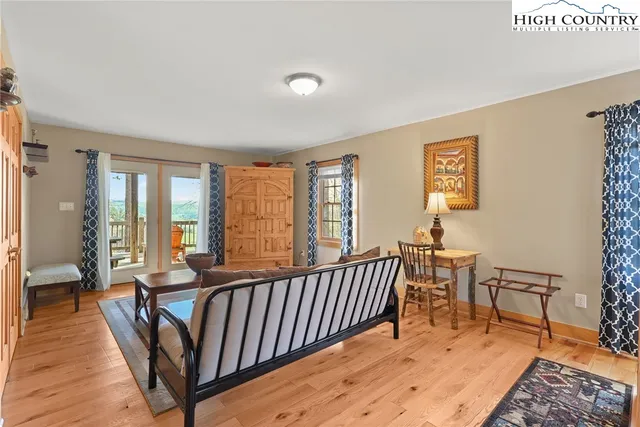 a living room with furniture wooden floor and a table