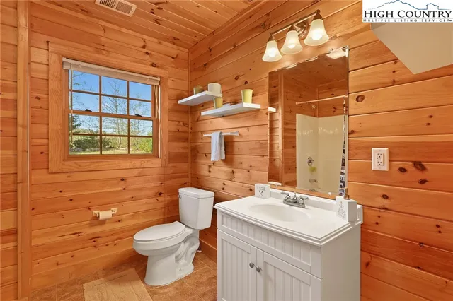 a bathroom with a sink a toilet and mirror